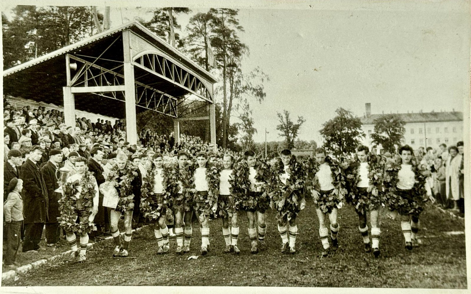 „Minijos“ futbolininkų garbės ratas stadiono taku su iškovota „Tiesos“ taure: (iš kairės) komandos kapitonas Ramutis Trumpenskas, Auseklis Birgelis, Romualdas Skurvydas, Vaclovas Brazdeikis, Romas Šalnis, Edvardas Valatka, Kazimieras Mačiulskis, Algirdas Andriuškevičius, Zenonas Meškauskas, Vladas Eitavičius, Stasys Bajelis. 1964 m. nuotr. iš Skurvydų šeimos archyvo
